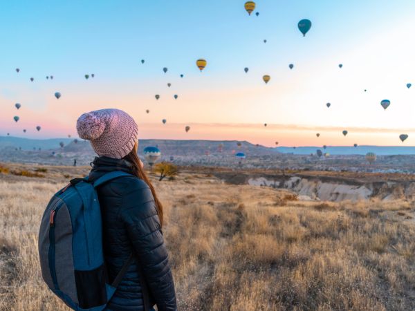 Woman admiring the beauty of Hot air balloon and the magic around it